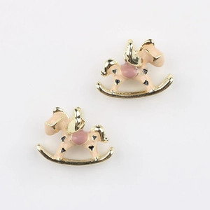 Detailed view of pink winged rocking horse charms with gold metal edges for DIY jewelry