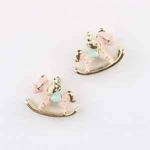 Detail showing a pair of pink enamel rocking horse charms with golden heart accents