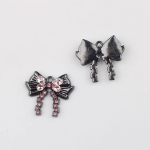 Detalle de colgante de lazo negro plomo con cristales rosas para joyería artesanal