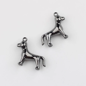 Macro view of twin puppy-shaped pendants in gunmetal mirror polish with secure top loops