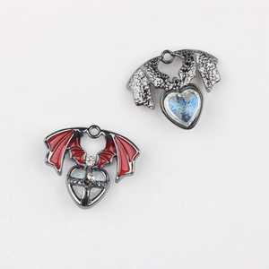 Detailed view of Gothic bat wing heart pendants with red enamel and blue galaxy finish