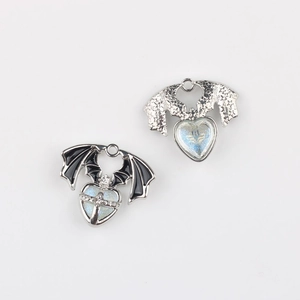 Detail of gothic alloy bat wing heart pendants with glitter enamel for DIY jewelry