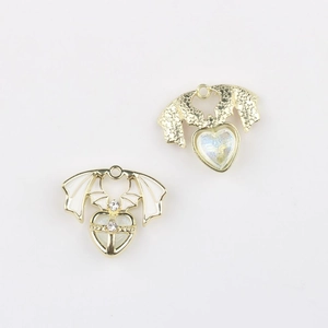 Detailed view of alloy bat wing heart pendants with dripping oil and zircon inlays