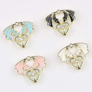 Detailed view of four winged heart alloy pendants with enamel filling and small rhinestones