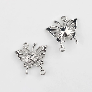 Detalle de colgantes de mariposa plateada con rosa 3D para accesorios de joyería DIY