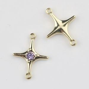 Detail of gold-plated star connector with purple zircon for DIY jewelry making