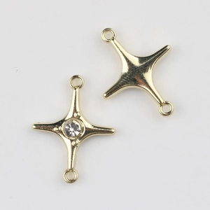 Close-up of gold alloy star connectors with zircon inlay for DIY jewelry accessories