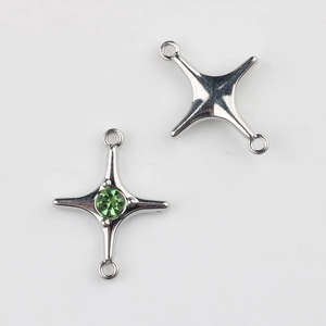 Detail view of silver star connectors with green zircon inlay for DIY jewelry making