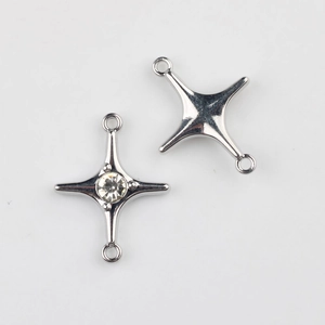 Detail of silver alloy star connectors with inset zircons for DIY jewelry making