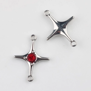 Detail of silver alloy star connector charms with red zircon inlay for DIY jewelry