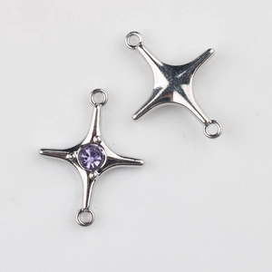 Macro detail of silver star connectors with purple zircon for DIY jewelry making