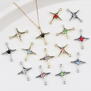 Macro shot of colorful zircon cross star charms for DIY jewelry making in gold and silver plating
