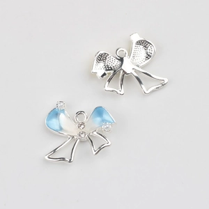 Detailed view of silver bow charm with blue enamel, pearls and zircon for DIY jewelry
