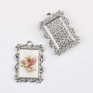 Detailed view of silver alloy angel pendant showing both front artwork and back texture