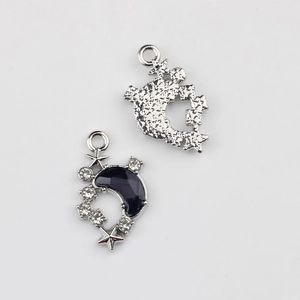 Detail of silver moon pendant with blue resin and white zircons showing both sides