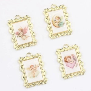 Detailed view of vintage gold alloy angel pendants with baroque embossed frames for DIY