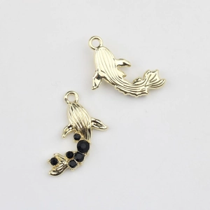 Detailed close-up of golden and black crystal mermaid pendants for DIY jewelry making