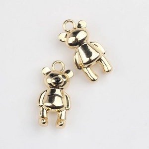 Macro detail of polished gold-tone alloy bear charm for DIY jewelry and necklaces