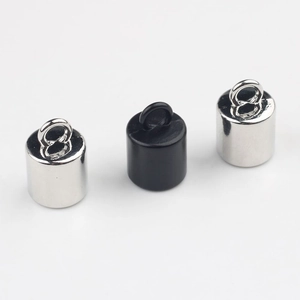Close-up of cylindrical alloy weight pendants in silver and black for DIY jewelry making