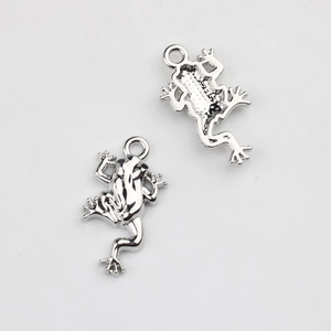 Macro view of silver frog charms with detailed front and hollow back for DIY jewelry making