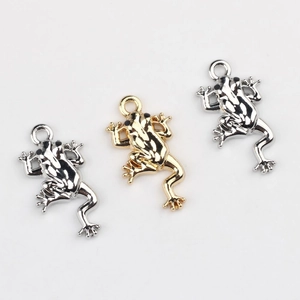 Detail showing frog-shaped alloy charms in gold and silver finish for DIY jewelry making