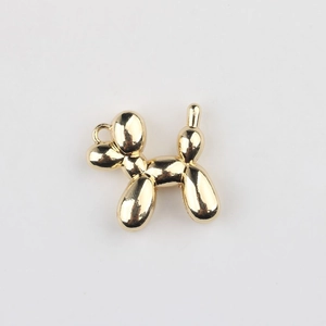 Macro detail of golden balloon dog pendant with mirror finish for DIY jewelry making