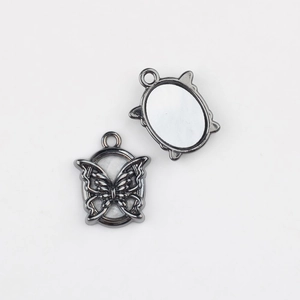 Macro detail of alloy butterfly pendant charm for DIY jewelry making with gunmetal finish