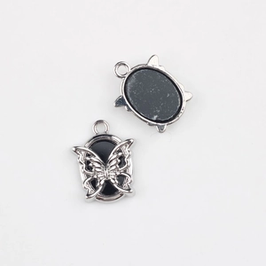 Detailed macro view of vintage alloy butterfly pendant for DIY jewelry making