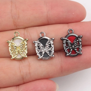 Handheld display of alloy butterfly charms with resin inlay in three metallic finishes