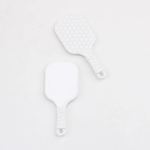 Close-up of white kitchen spoon with non-stick honeycomb texture and anti-slip handle