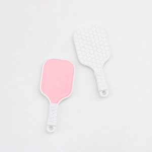Close-up of pink and white silicone facial brushes with textured heads and non-slip handles