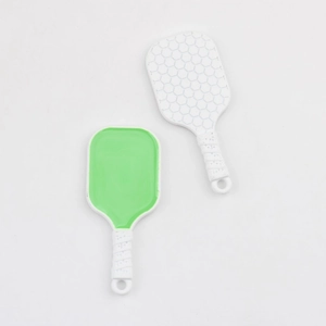 Macro view of green and honeycomb pattern white pickleball paddle pendants for DIY jewelry
