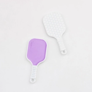 Close-up of pickleball paddle pendants with honeycomb texture and anti-slip handles