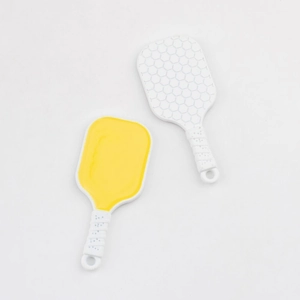 Detail showing colorful pickleball paddle charms with smooth and honeycomb textures