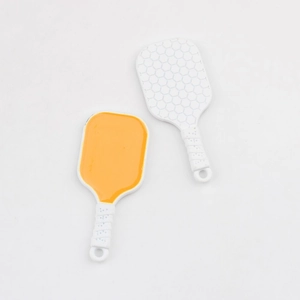 Detail shot of mini alloy tennis racket charms in yellow and white for DIY jewelry making