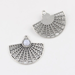 Detailed macro of bohemian hollow fan pendants with marble stone inlay for DIY jewelry