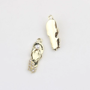 Detail of golden flip-flop charm with pearl and crystals for DIY jewelry making