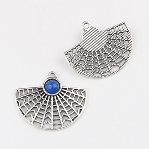 Macro detail of fan-shaped silver alloy pendants with blue resin stone for DIY jewelry