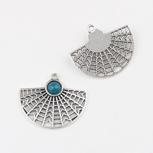 Detail of fan-shaped alloy pendant with turquoise resin bead and vintage silver finish