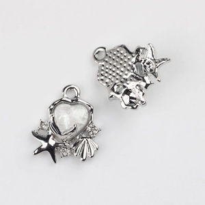 Detail of silver alloy heart pendant with sea shell and starfish for DIY jewelry