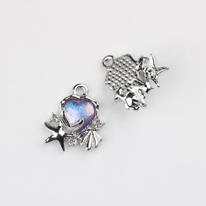 Detail of sea-themed heart charm with blue-purple gradient resin, starfish and shell