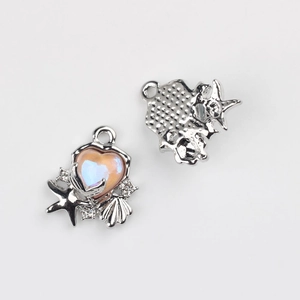 Detailed view of silver heart pendant with starfish shell accents and pink iridescent inlay
