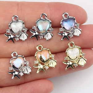 DIY ocean charms with starfish shells and resin hearts in golden and silver settings