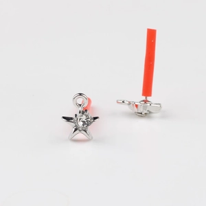Detail of silver star earrings featuring zircon stones and stainless steel pin backs