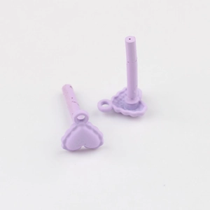 Macro shot of two light purple matte heart earring charms with vertical posts for DIY jewelry