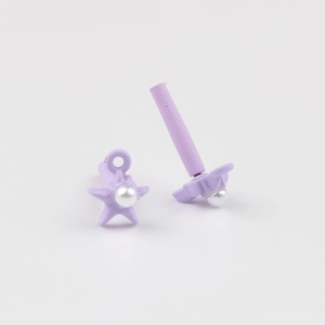 Detailed view of purple star-shaped earring parts with matte finish and pearl inlay