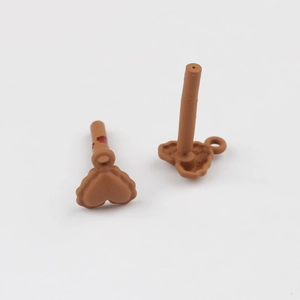 Close-up of brown heart-shaped alloy pendant charms for DIY jewelry making accessories