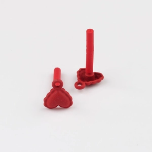 Macro shot of red heart earring studs with matte finish and wavy textured edges