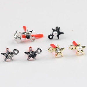 Detailed view of alloy star charms with pearl and zircon inlay for DIY jewelry making