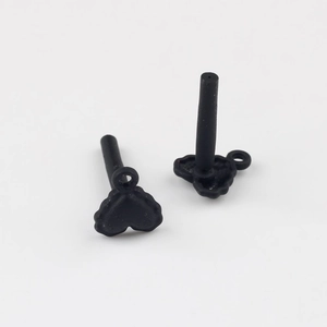 Close-up of matte black heart-shaped earring studs with small hanging loops for DIY